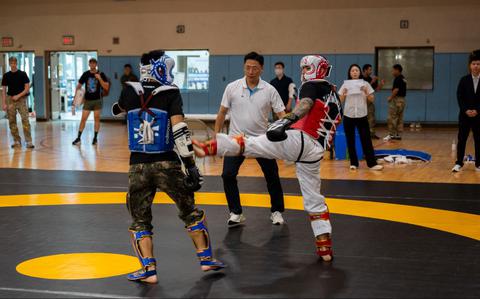 Photo Of U.S. Army Capt. Davon Stuart, right, 524th Military Intelligence Battalion officer in charge, lands a kick during the 2025 ROK-US Combat Taekwondo Exhibition.