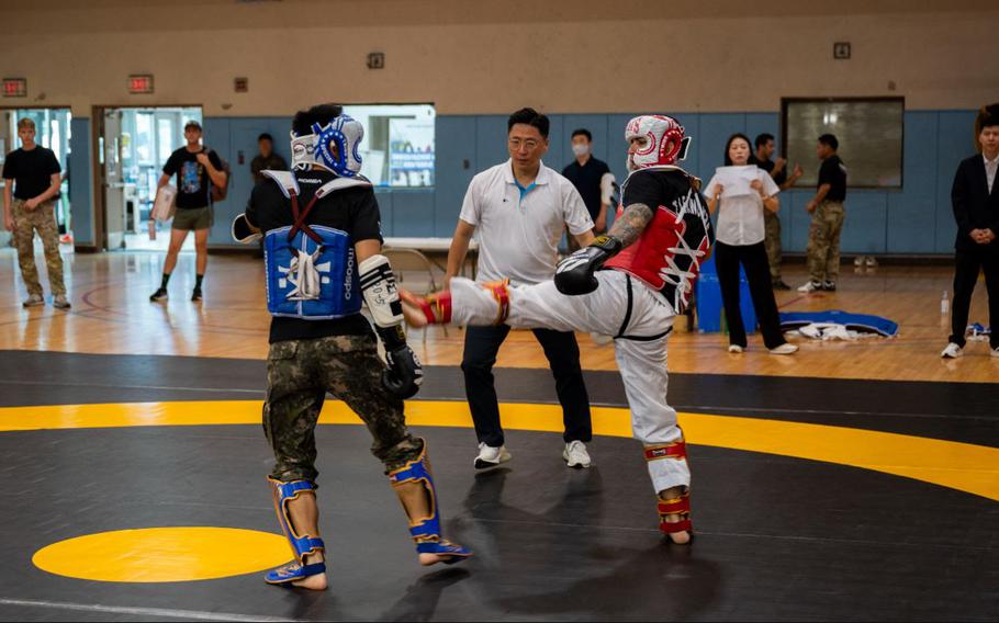 U.S. Army Capt. Davon Stuart, right, 524th Military Intelligence Battalion officer in charge, lands a kick during the 2025 ROK-US Combat Taekwondo Exhibition.