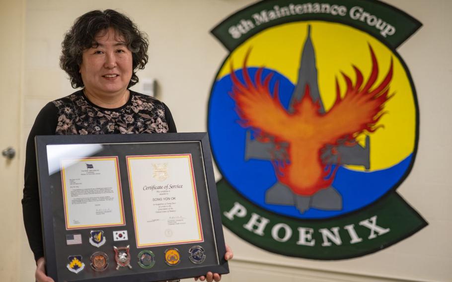 Yon Ok Song, 8th Maintenance Group maintenance system specialist, holds a framed certificate awarded to her for her 40 years of service at Kunsan Air Base, Republic of Korea April 3, 2024. Song began working at Kunsan AB in 1984 and has since closely worked with the 80th and 35th Fighter Generation Squadrons to improve the efficiency of the 8th Fighter Wing’s flying missions.