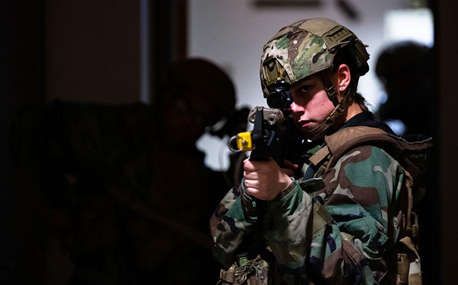 Airman 1st Class Aislinn Molina, 8th Security Forces Squadron installation entry controller, aims her M4 Carbine Rifle while keeping watch during an opposition force training event with the 8th Communications Squadron during Beverly Pack 23-2 at Kunsan Air Base, Republic of Korea, Aug. 22, 2023. The 8th SFS personnel were evaluated on their use of Tactical Combat Casualty Care, cover and team movements from room to room. (U.S. Air Force photo by Senior Airman Karla Parra)