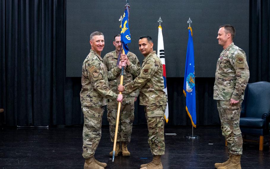 U.S. Air Force Col. Douglas Mabry, left, 694th Intelligence, Surveillance, and Reconnaissance group commander, passes the guidon to Lt. Col. Ryan Tamez, incoming 6th Intelligence Squadron commander, at Osan Air Base, Republic of Korea.