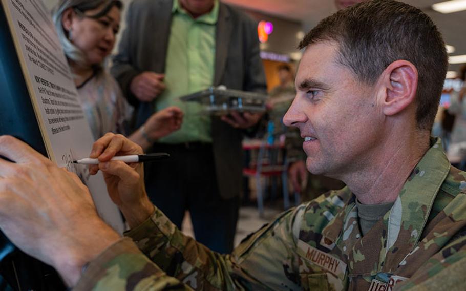 Col. Timothy B. Murphy, 8th Fighter Wing commander, signs the 2023 suicide prevention proclamation affirming support for Suicide Prevention and Awarenesss efforts at Kunsan Air Base, Republic of Korea, Sept. 8, 2023. 8th FW leaders signed the proclamation and prevention pledge to promote mental health awareness and suicide prevention programs available at Kunsan AB. (U.S. Air Force photo by Staff Sgt. Samuel Earick)