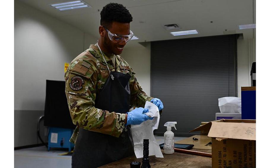 Airman 1st Class Jaylin Tripp, 8th Maintenance Squadron nondestructive inspection specialist, cleans a piece of aircraft equipment after testing at Kunsan Air Base, Republic of Korea, Mar. 6, 2023. The 8th Maintenance Squadron nondestructive inspection flight is responsible for examining aircrafts for cracks and inspecting oil for contaminants and metal wear. (U.S. Air Force photo by Senior Airman Shannon Braaten)