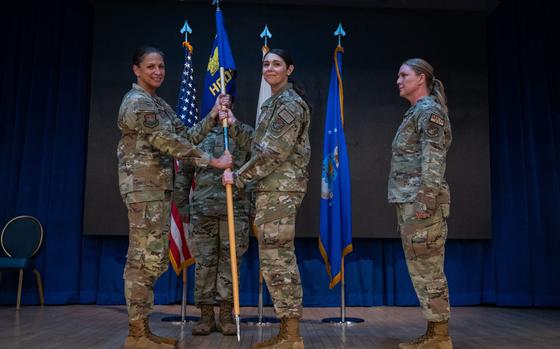 U.S. Air Force Lt. Col. Joanna Cooley, middle, accepts command of the 51st Healthcare Operations Squadron from Col. Mocha Robinson, 51st Medical Group commander, left, during a change of command ceremony at Osan Air Base, Republic of Korea, June 18, 2024.