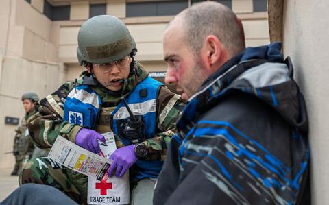 Photo Of U.S. Air Force Capt. John Namgoong, 51st Medical Group triage officer, speaks to a simulated triage patient in a mass casualty training event during Beverly Midnight 24-1 at Osan Air Base, Republic of Korea, Feb. 1, 2024.