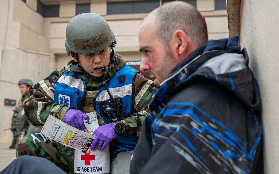 U.S. Air Force Capt. John Namgoong, 51st Medical Group triage officer, speaks to a simulated triage patient in a mass casualty training event during Beverly Midnight 24-1 at Osan Air Base, Republic of Korea, Feb. 1, 2024. The 51st MDG medics prepare daily for any contingencies if and when they occur, with the foremost priority being ready to fight tonight. BM24-1 is a routine training event that tests the military capabilities across the peninsula, allowing combined and joint training at both the operational and tactical levels. 