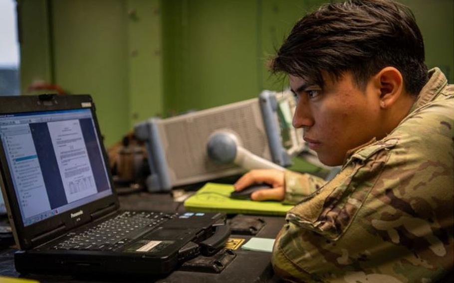 U.S. Air Force Senior Airman Carlos Perez Ortiz, 607 Air Communications Squadron, radio frequency transmission system technician, works to establish a network connection to a ground multiband terminal during exercise Enduring PACE, May 18, 2023, at Osan Air Base, Republic of Korea. Exercise Enduring PACE aimed at establishing operational-to-tactical communications linkages, which are essential for command and control during contingencies. (U.S. Air Force photo by Master Sgt. Kenneth W. Norman)