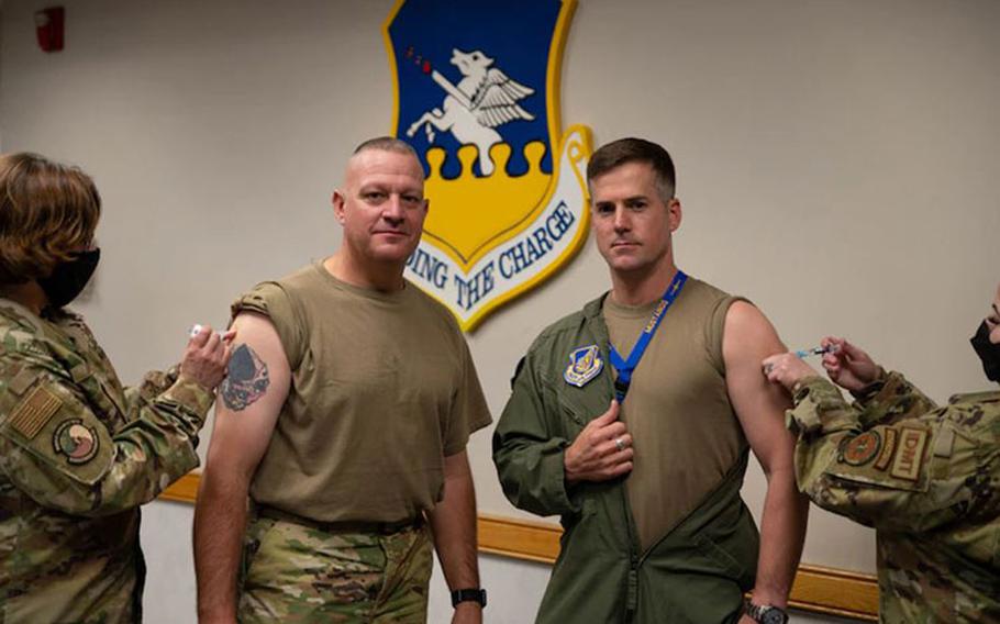 Chief Master Sgt. Justin Apticar, 51st Fighter Wing command chief (left), and Col. Joshua Wood, 51st Fighter Wing commander, receive their flu shots at Osan Air Base, Republic of Korea, September 17, 2021. The flu shot is now available at Osan for all active-duty personnel. (U.S. Air Force photo by Senior Airman Kevyn Allen)