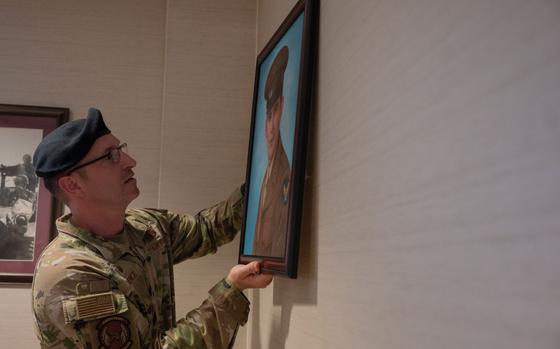 U.S. Air Force Lt. Col. Nicholas Brence, 51st Security Forces Squadron commander, hangs a portrait of Corporal Joseph Morin at Osan Air Base, Republic of Korea, June 27, 2024.