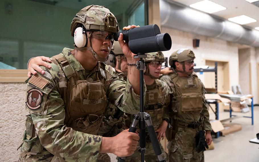 U.S. Air Force Senior Airman Josiah Griggs, 51st Security Forces Squadron Defender, reviews the accuracy of his teammates after firing while training for a major command-wide Advanced Combat Skills Assessment at Osan Air Base, Republic of Korea, July 28, 2023. In addition to marksmanship, the team will compete against Defenders across the Pacific in range estimation, hand-to-hand combatives, physical fitness and land navigation through jungle terrain. (U.S. Air Force photo by Senior Airman Trevor Gordnier)