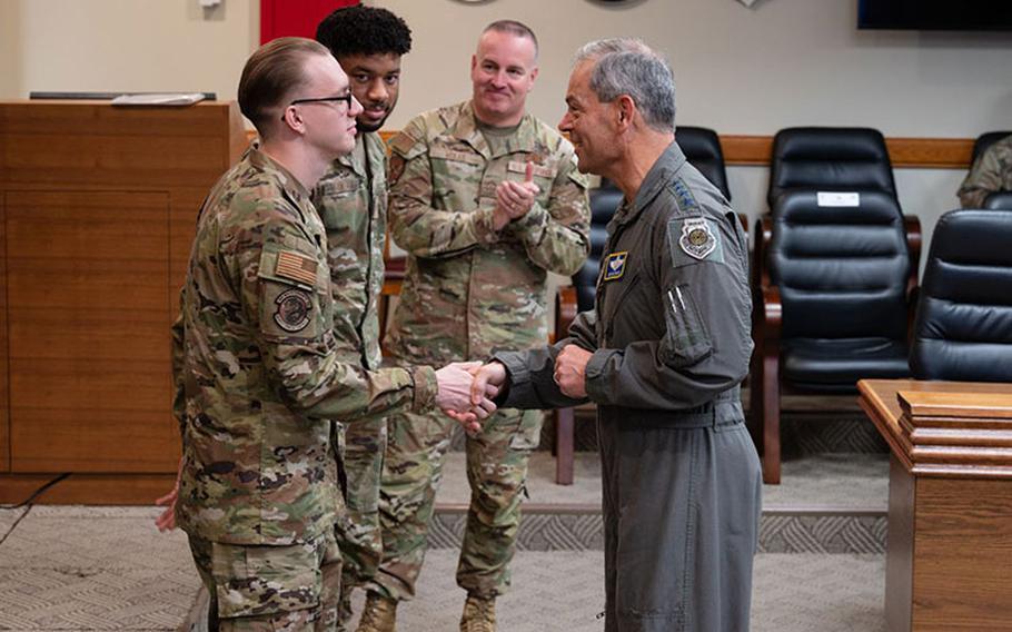 Gen. Ken Wilsbach, Pacific Air Forces commander, coins Senior Airman Christopher Smith, 8th Aircraft Maintenance Squadron Egress Systems journeyman, during his visit at Kunsan Air Base, Republic of Korea Oct. 20, 2023. Wilsbach and Chief Master Sgt. David R. Wolfe, PACAF command chief, commended the efforts of standout 8th Fighter Wing Airmen for ensuring the Wolf Pack’s ‘Fight Tonight’ mission. (U.S. Air Force photo by Staff Sgt. Jovan Banks)