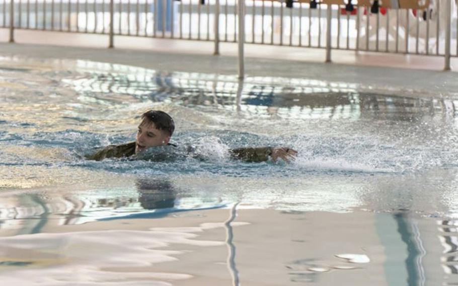 Sgt. James P. Parker III swims across the Camp Walker Aquatics Center pool before a reenlistment ceremony February 25, 2022. Parker said he wanted to reenlist at the aquatics center because he has found Army water training to be the most challenging. (Photo Credit: U.S. Army photo by Mathew Gleeson)