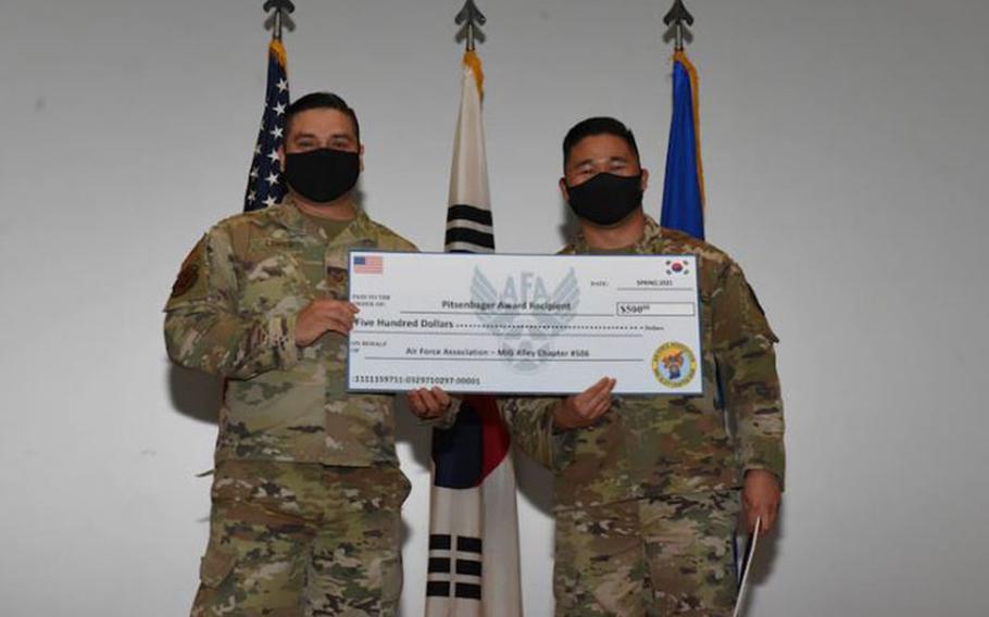 Staff Sgt. Angelo Patungan, 51st Logistics Readiness Squadron, receives the Pitsenbarger Award at a Community College of the Air Force graduation ceremony on Osan Air Base, Republic of Korea, April 13, 2021. (U.S. Air Force photo by Staff Sgt. Douglas Lorance)