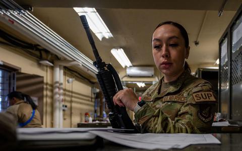 Photo Of Tech. Sgt. Victoria Kohagen 8th Logistics Readiness Squadron individual protective equipment non-commissioned officer in charge, inspects paperwork before checking out an M4 carbine rifle in preparation for Beverly Sentinel 24-1 at Kunsan Air Base, Republic of Korea, March 21, 2024.