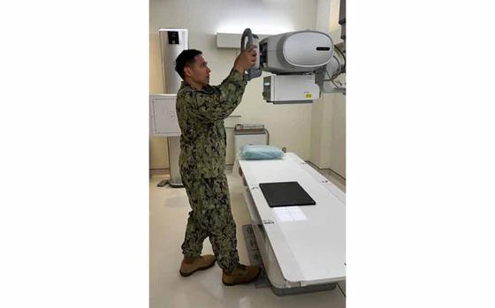 Photo Of Hospital Corpsman 1st Class Louie Solomon, a native of Carson, Calif., adjusts an X-ray machine. Solomon is X-ray technician at the Branch Health Clinic (BHC) Chinhae, a tenant command at Fleet Activities Chinhae (CFAC), Navy Region Korea (CNRK).