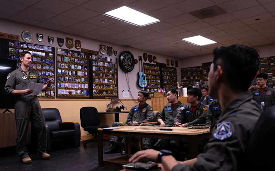 U.S. Air Force Capt. Tyler Rico, 80th Fighter Squadron pilot, conducts a briefing to Republic of Korea Air Force pilots during a mission immersion at Kunsan Air Base, ROK, Oct. 4, 2023. The ROKAF pilots were given information from the 80th FS detailing how flight procedures and planning are conducted during normal and contingency operations. (U.S. Air Force photo by Staff Sgt. Jovan Banks)