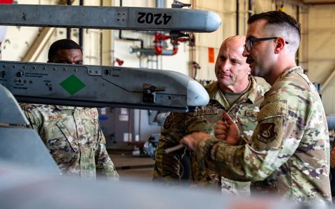 Photo Of Chief Master Sgt. Thomas Schaefer II, Seventh Air Force command chief, and Tech. Sgt. Branden Genovese, 8th Maintenance Group loading standardization crew member, discuss F-16 Fighting Falcon hardpoint capabilities at Kunsan Air Base, Republic of Korea.