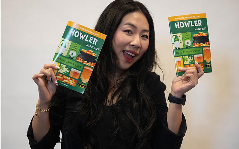 Kelly Roh, 8th Force Support Squadron marketing assistant, showcases the 8th FSS Howler magazine at Kunsan Air Base, Republic of Korea, March 13, 2023. Roh is responsible for crafting the monthly magazine that contains information on upcoming base events, recurring event details and resources for military members. (U.S. Air Force photo by Staff Sgt. Isaiah J. Soliz)