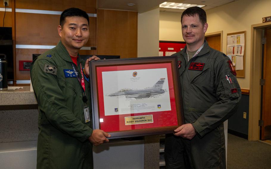 U.S. Air Force Lt. Col. Farrer, 36th Fighter Squadron commander, presents a plaque to Republic of Korea Air Force Maj. Youngdo Park, 122nd FS vice commander, closing Buddy Squadron 24-2 at Osan Air Base Republic of Korea, March 8, 2024.