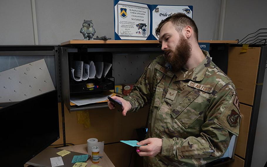 Senior Airman Calvin Cook, 8th Comptroller Squadron financial operations technician, fields a customer phone call at Kunsan Air Base, Republic of Korea, April 4, 2023. Cook holds several positions and titles in addition to financial operations technician, such as the lead defense travel administrator, organizational defense travel administrator, travel pay technician and more. (U.S. Air Force photo by Senior Airman Akeem K. Campbell)