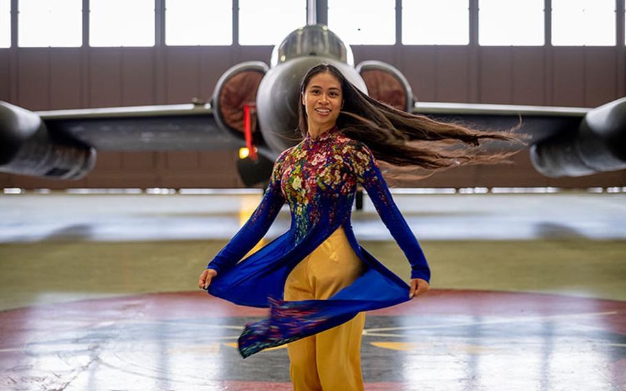 1st Lt Quynh Tran, 5th Reconnaissance Squadron chief of intelligence, poses in an "ao dai" next to a U-2S reconnaissance aircraft at Osan Air Base, April 22, 2022. (U.S. Air Force photo by Master Sgt. Joshua J. Garcia)