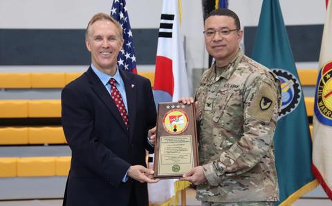 Photo Of Col. Henry Brown, commander, 403rd Army Field Support Brigade, and Gordon “Buzz” Hackett, deputy to the commander, 403rd AFSB, display the runner-up plaque presented to LRC-Okinawa during the 2024 Army Award for Maintenance Excellence Ceremony at Kelly Fitness Center on Camp Walker, South Korea.