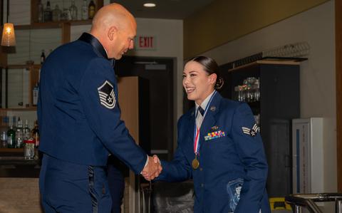 Photo Of U.S. Air Force Master Sgt. Benjamin Malotte, 51st Fighter Wing Airman Leadership School commandant, left, and Senior Airman Ellie Wilbourn, 7th Air Force Joint Worldwide Intelligence Communications System administrator, shake hands during an ALS graduation at Osan Air Base, Republic of Korea, March 21, 2024.
