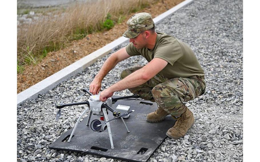 Senior Airman William Gebhardt, 8th Civil Engineer Squadron construction inspector, adjusts a Rapid Airfield Damage Assessment System (RADAS) Small Unmanned Aircraft during a recovery operation in waters near Kunsan Air Base, Republic of Korea, July 14, 2021. The RADAS was used to survey the debris after two fuel tanks were jettisoned from an F-16C Fighting Falcon during a training sortie. (U.S. Air Force photo by Staff Sgt. Steven M. Adkins)