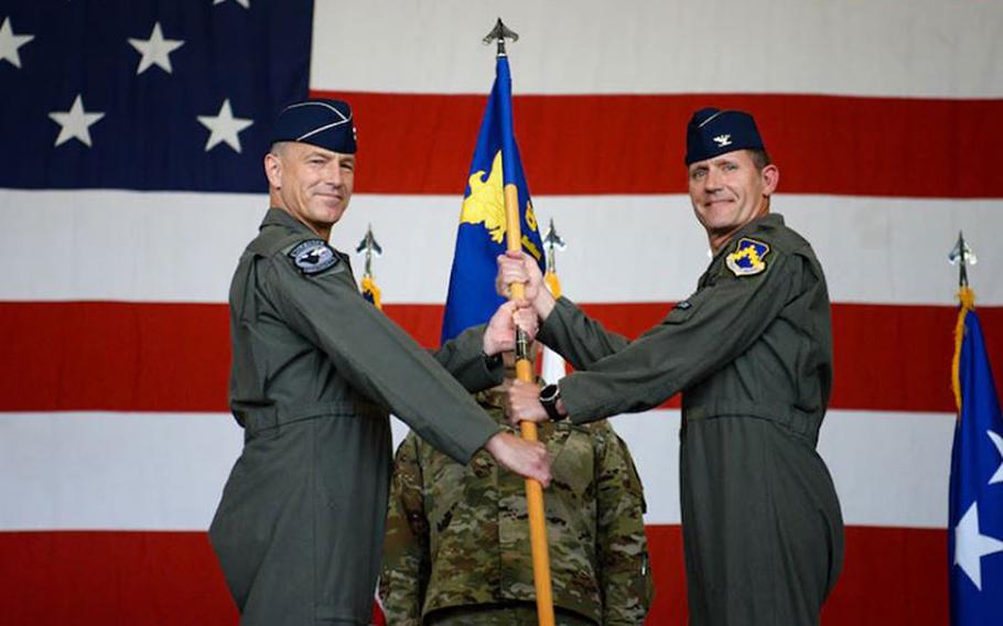 Lt. Gen. Scott Pleus, Seventh Air Force commander, presents the ceremonial guidon to Col. John Gallemore during the 8th Fighter Wing change of command at Kunsan Air Base, Republic of Korea, June 1, 2021. Col. John Gallemore, 8th FW incoming commander, assumed command of the 8th FW from the outgoing commander, Col. Christopher Hammond. (U.S. Air Force photo by Staff Sgt. Mya M. Crosby