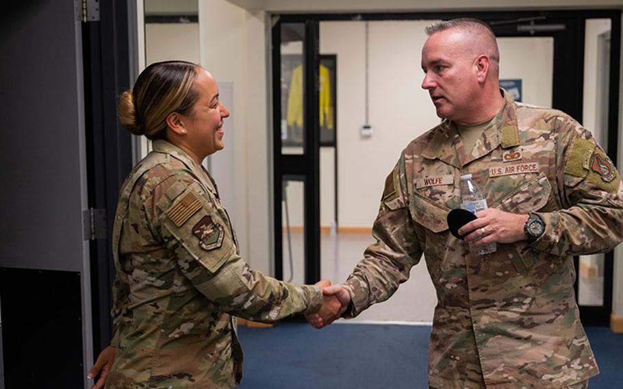 Chief Master Sgt. David Wolfe, right, Pacific Air Forces command chief, presents a coin to Tech. Sgt. Emeliana Punahele-Yau, 51st Fighter Wing Airman Leadership School instructor, during his visit to Kunsan Air Base, Republic of Korea, June 13, 2023. Wolfe took time during his visit to talk with future leaders of the U.S. and Republic of Korea Air Forces currently attending Airman Leadership School. (U.S. Air Force photo by Staff Sgt Samuel Earick)