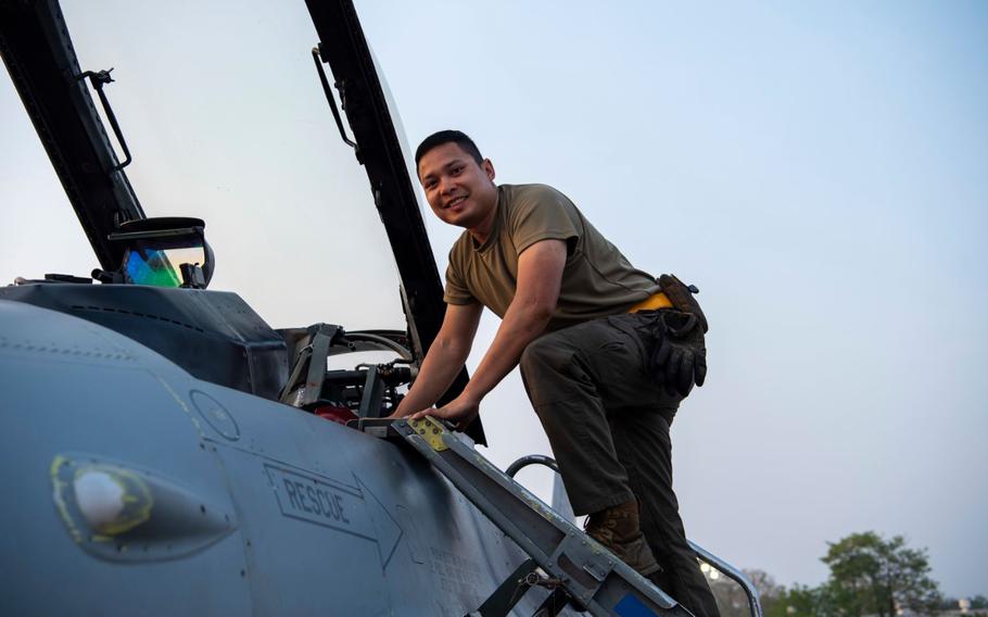 Airman 1st Class Chanon Absomtua, 80th Fighter Generation Squadron crew chief, climbs down from the cockpit of an F-16 Fighting Falcon during Joint Exercise Cobra Gold 24 at Korat Royal Thai Air Force Base, Thailand, March 4, 2024. Absomtua grew up in Thailand before moving to the U.S. as a child and has taken this opportunity to share cultural insights with his teammates who are visiting Thailand for the first time during Gobra Gold.