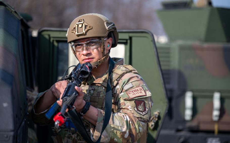 U.S. Air Force Airman 1st Class Christian Fernandez, 51st Communications Squadron cyber systems technician, scans the area for simulated opposing forces during a Combat Readiness Course at Osan Air Base, Republic of Korea, March 14, 2024.