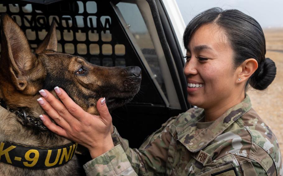 Senior Airman Georgina Silva, 8th Security Forces Squadron Military Working Dog handler, spends a moment with MWD Dirty after training together at Kunsan Air Base, Republic of Korea Feb. 8, 2024. Silva was recognized for showcasing incredible professionalism when responding to a high-risk, high-pressure situation and safeguarding Kunsan AB assets.