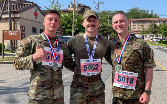 U.S. Air Force Airmen pose for a photo after placing in the top three during the Norwegian Foot March Foreign Military Badge ceremony at Osan Air Base, Republic of Korea, June 21, 2024.
