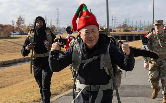 Eighth Army Col. (Chaplain) Charlie Lee raises cheers while finishing the Toy Ruck March on Camp Humphreys, South Korea, Dec. 6, 2024.