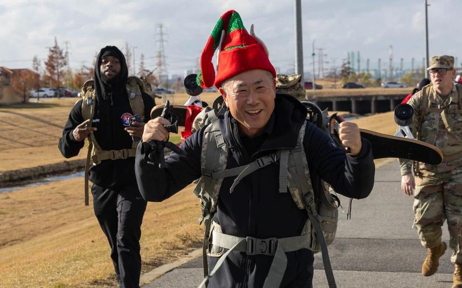 Eighth Army Col. (Chaplain) Charlie Lee raises cheers while finishing the Toy Ruck March on Camp Humphreys.