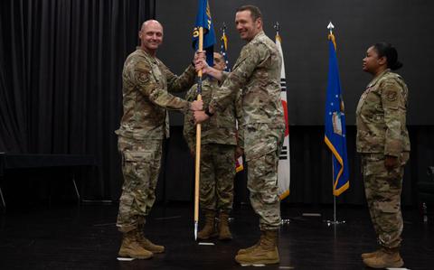 Photo Of U.S. Air Force Col. Jeff Elliott, left, 51st Mission Support Group commander, passes the guidon to Lt. Col. Edmund Ward, right, incoming 51st Force Support Squadron commander, during a Change of Command ceremony at Osan Air Base, Republic of Korea.
