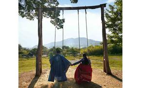 The author and her husband in Hanbok (traditional Korean cloth) and on swing.