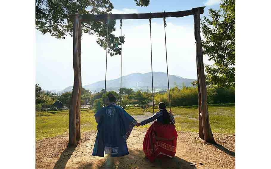 The author and her husband in Hanbok (traditional Korean cloth) and on swing.
