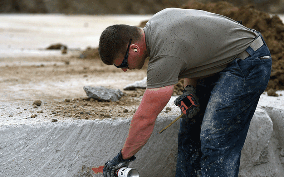 Senior Airman Christopher Brown, 51st Civil Engineering Squadron heavy equipment operator, marks inside a simulated crater during the 51st CES’ biannual rapid airfield damage repair training on Osan Air Base, Republic of Korea, September 12, 2019. When repairing a damaged airfield, there are two layers of concrete that need to be leveled and set in order for the airfield to be back to mission ready. (U.S. Air Force photo by Senior Airman Denise M. Jenson)