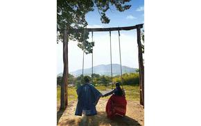 The author and her husband in Hanbok (traditional Korean cloth) and on swing.
