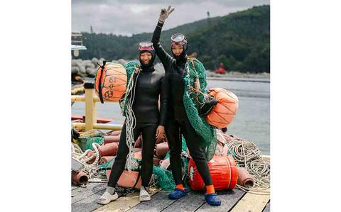 Photo Of two haenyeoes (sea women, female divers) posing for a photo