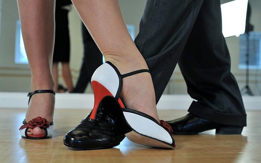 a woman and a man’s feet while dancing