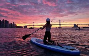 a woman paddleboarding