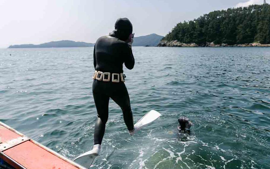 A haenyeo jumping off a boat.