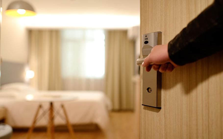 opening a door to enter hotel room